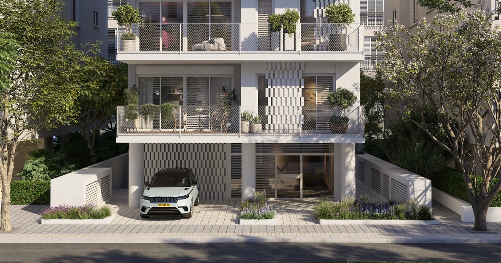 A Bauhaus apartment building on a tree-lined street in central Tel Aviv.